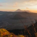 A stunning sunrise view of Mount Bromo and its surrounding landscape in Sukapura, East Java, Indonesia.